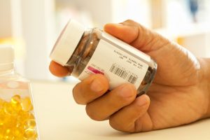 person reading label on supplement container